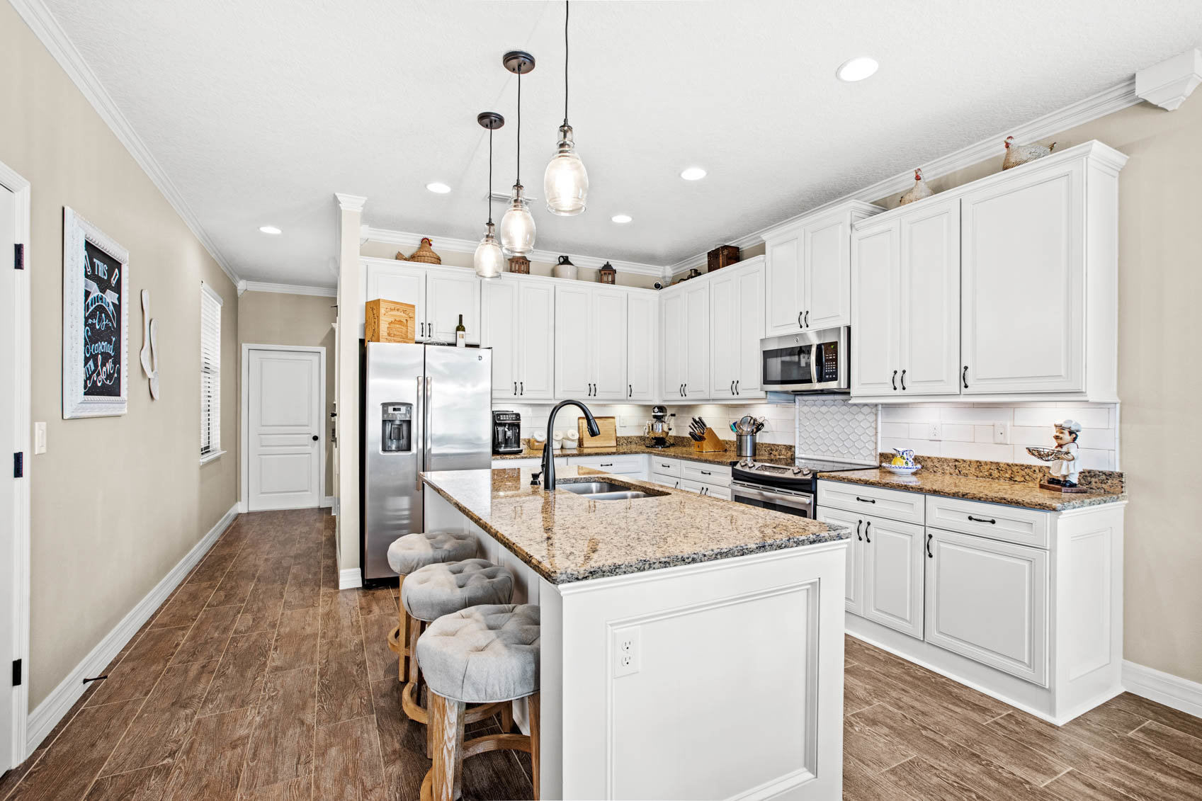 kitchen with front foyer and white cabinets